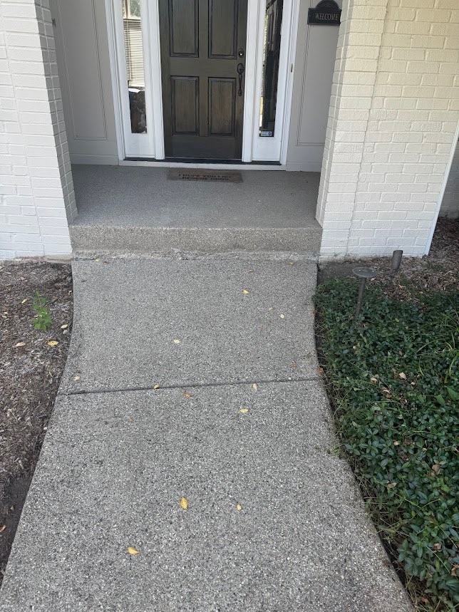 Same concrete walkway after pressure washing by Hahn Power Wash — bright, clean concrete