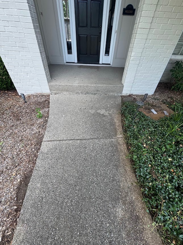 Concrete front walkway in Carmel, Indiana before pressure washing — dark, dirty concrete